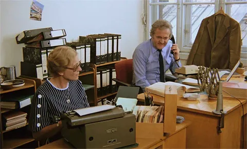 Filmszene aus WEHE, WENN SCHWARZENBECK KOMMT …! im Büro der Finanzamt-Leitung mit Hans Fries als Finanzamtleiter und in einer Gastrolle Hedwig Enke, die Mutter von Werner Enke, beide am Schreibtisch sitzend